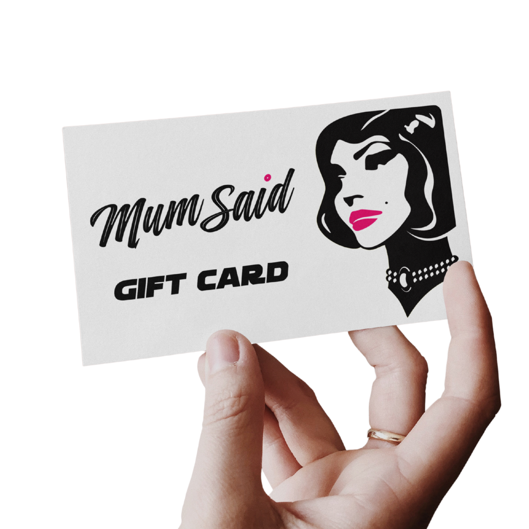Hand holding a 'Mum Said' gift card with the Mum Said Coffee Mascot design on a white background. 