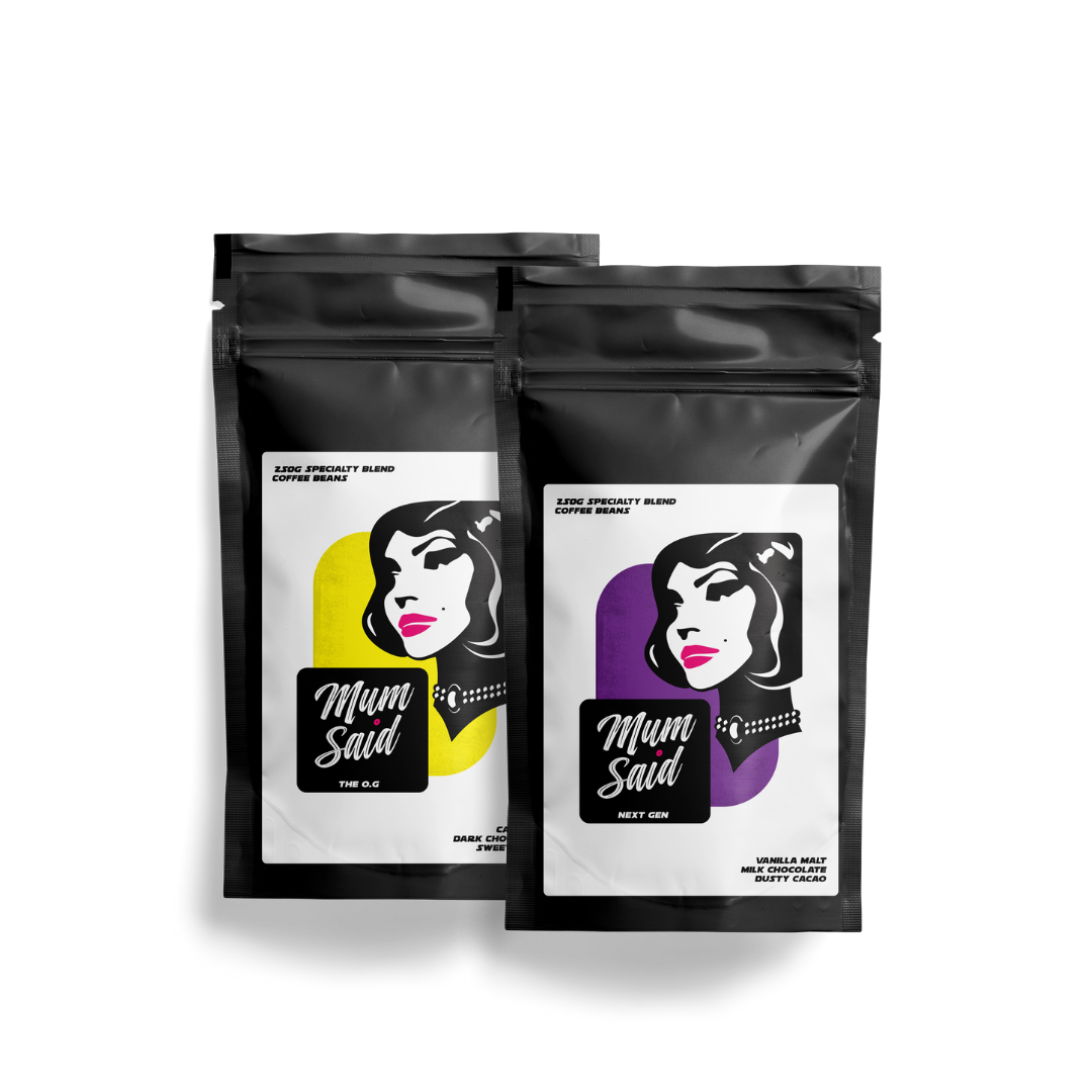 Two small black coffee bags with a woman's face design and 'Mum Said' branding on a white background. The Mum Said Taster Pack contains 20g of The OG and 250g of Next Gen.